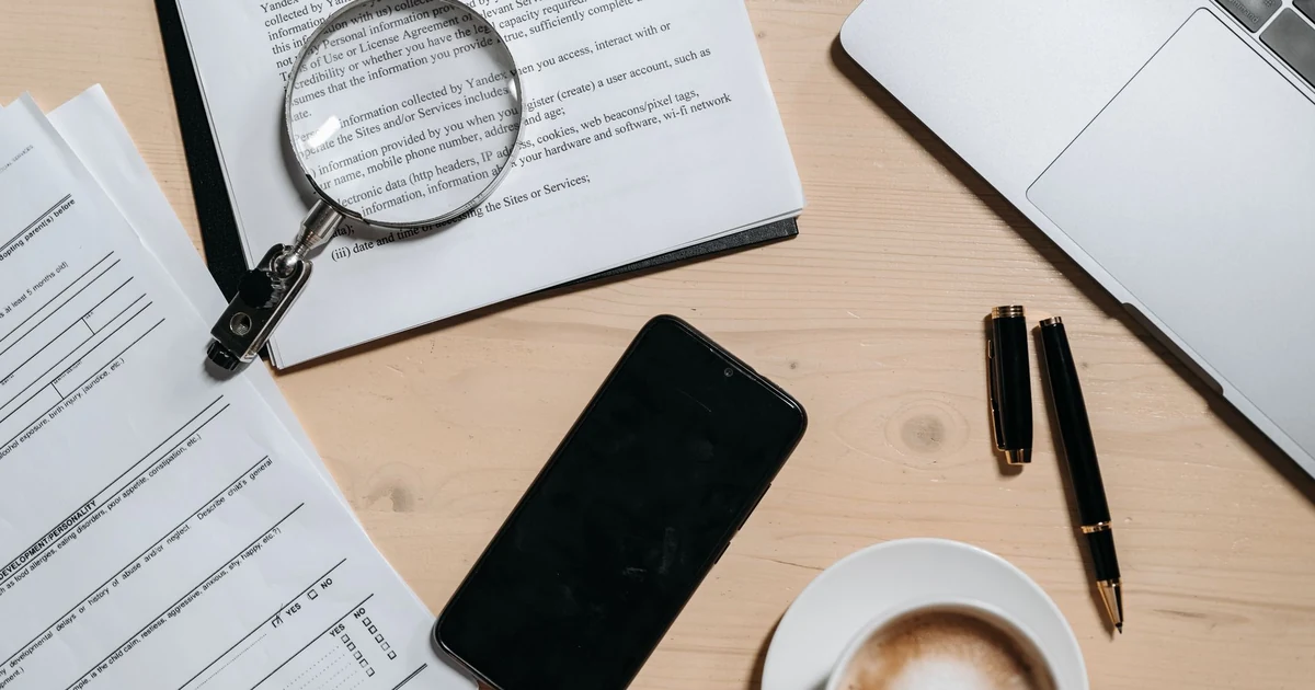 Magnifying glass over a digital document highlighting contract checklist items